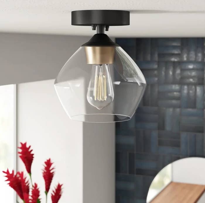 An image of a simple dome semi flush mount light with canopy, downrod, and bulb included