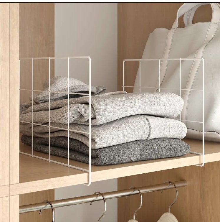 An image of a metal and plastic shelf divider that attaches to closet shelves