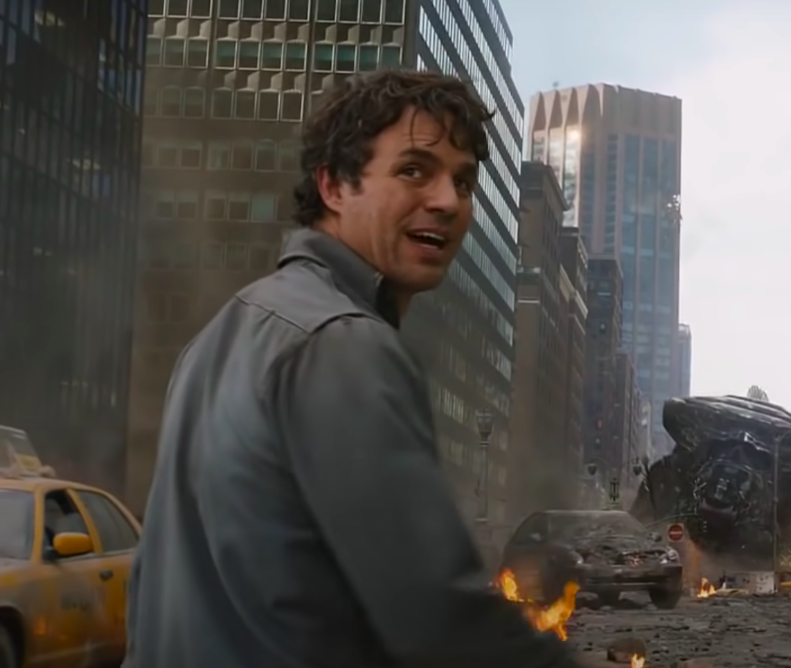 Mark Ruffalo in character on a burned street