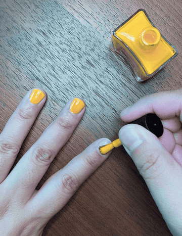 GIF of the writer applying the polish to their nails