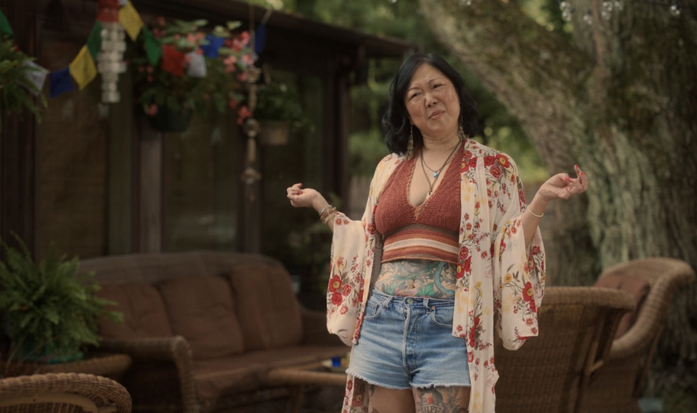 Cho in denim shorts and halter top and shawl