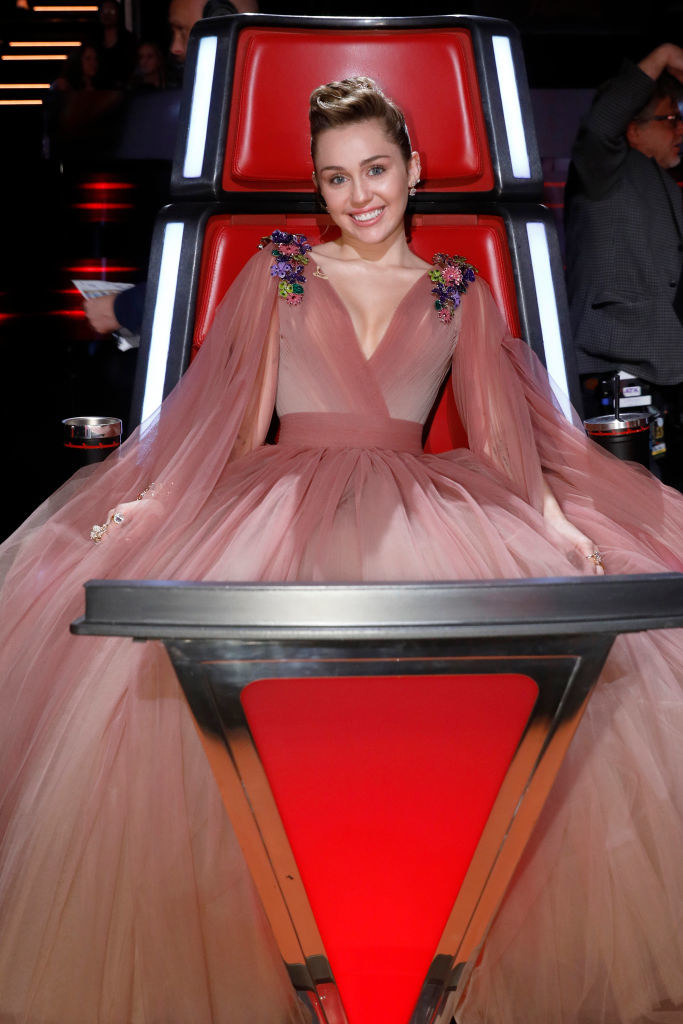 Miley sitting in the chair for The Voice