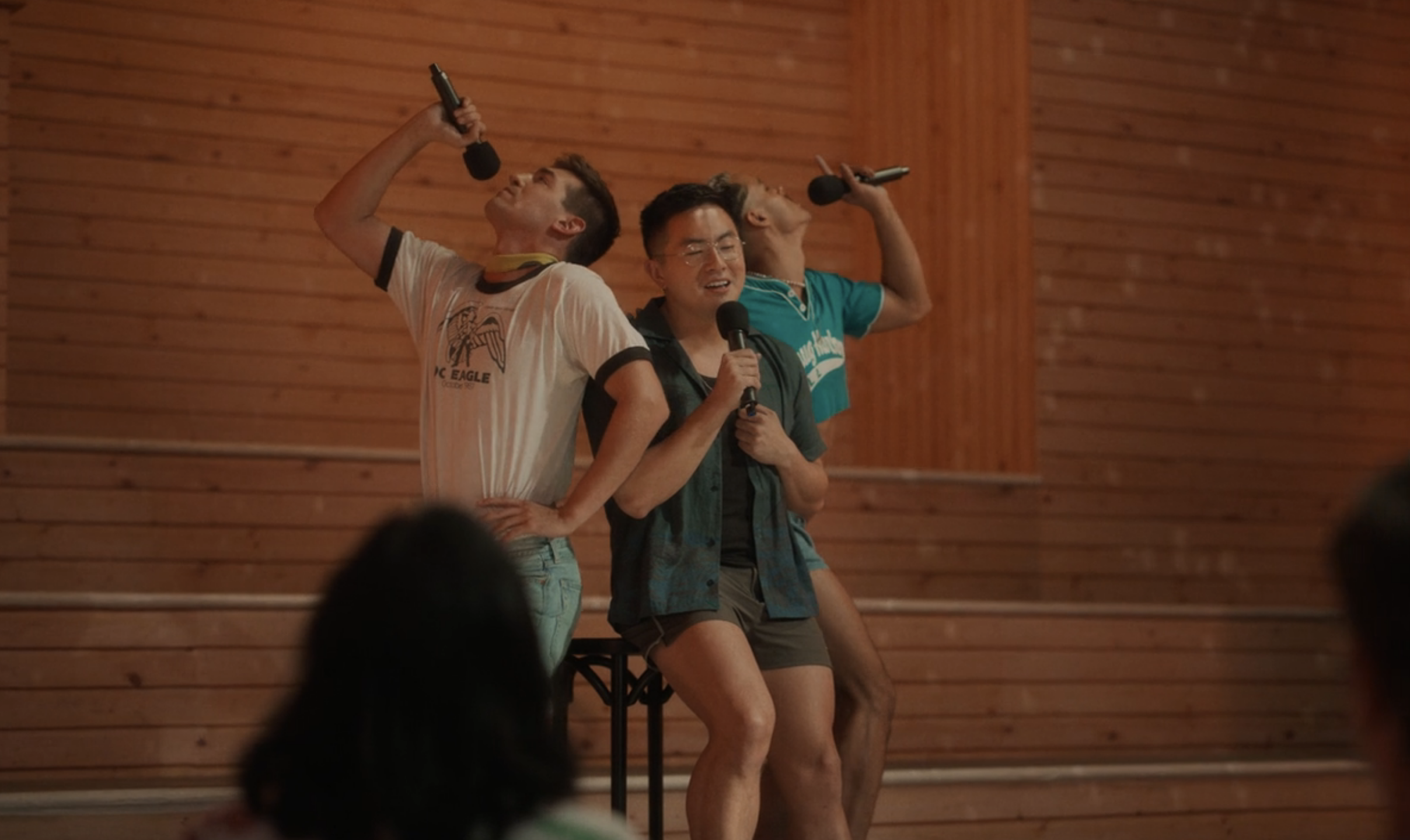 The three men — Rogers, Yang, and Matos — sing into microphones