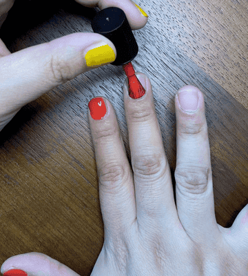 GIF of the writer applying the red nail polish
