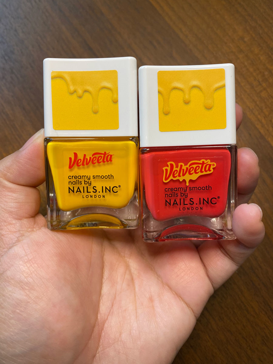 The bottles of nail polish feature an image of melting cheese on the tops