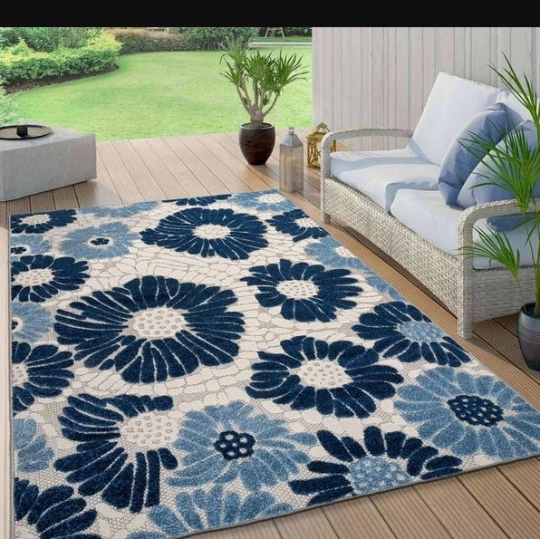 An image of a floral indoor/outdoor rug made from stain-resistant polypropylene materials