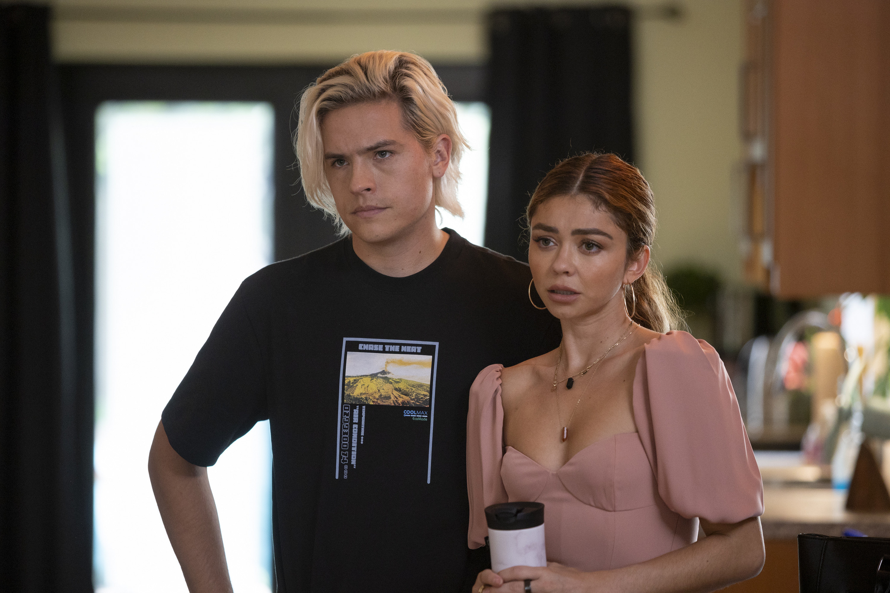 Dylan Sprouse and Sarah Hyland stand together