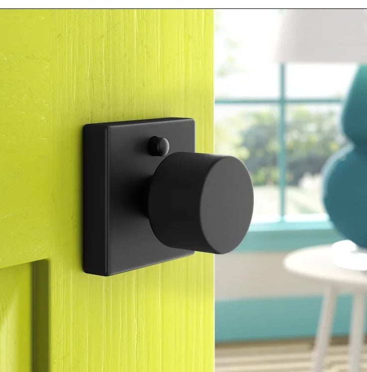 An image of a flat black door knob included in a set of six
