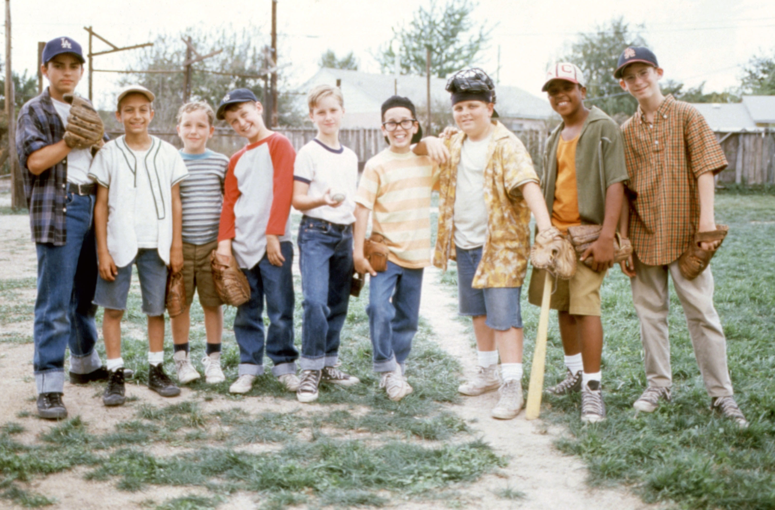 The team stands on a baseball diamond