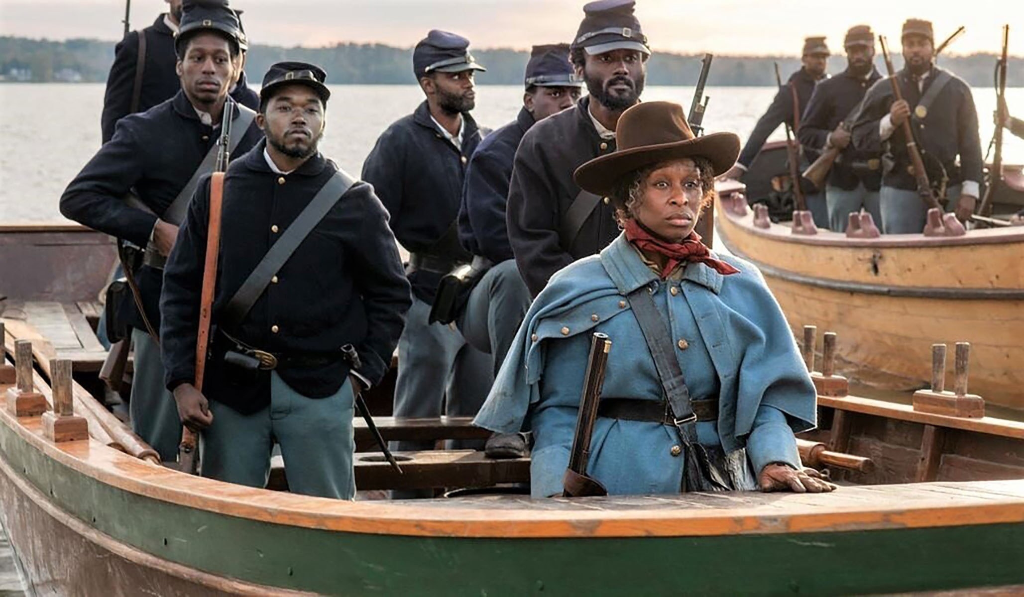 Cynthia Erivo stands in the front of a boat of soldiers
