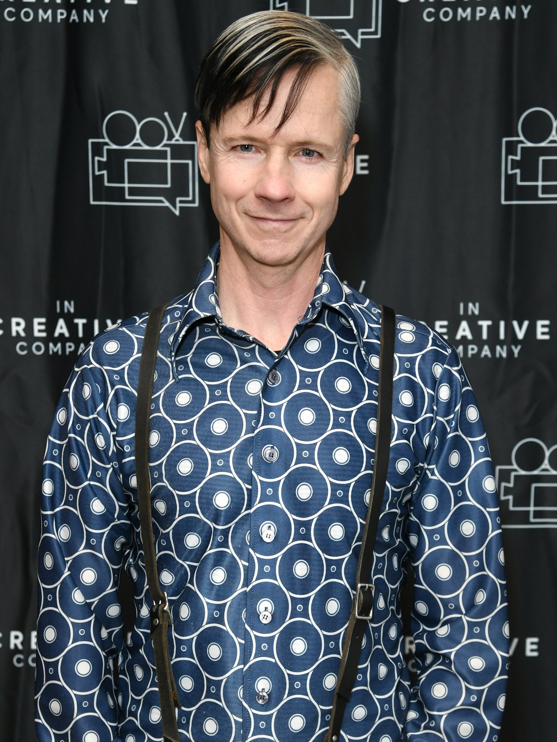 John Cameron Mitchell smiles at an event