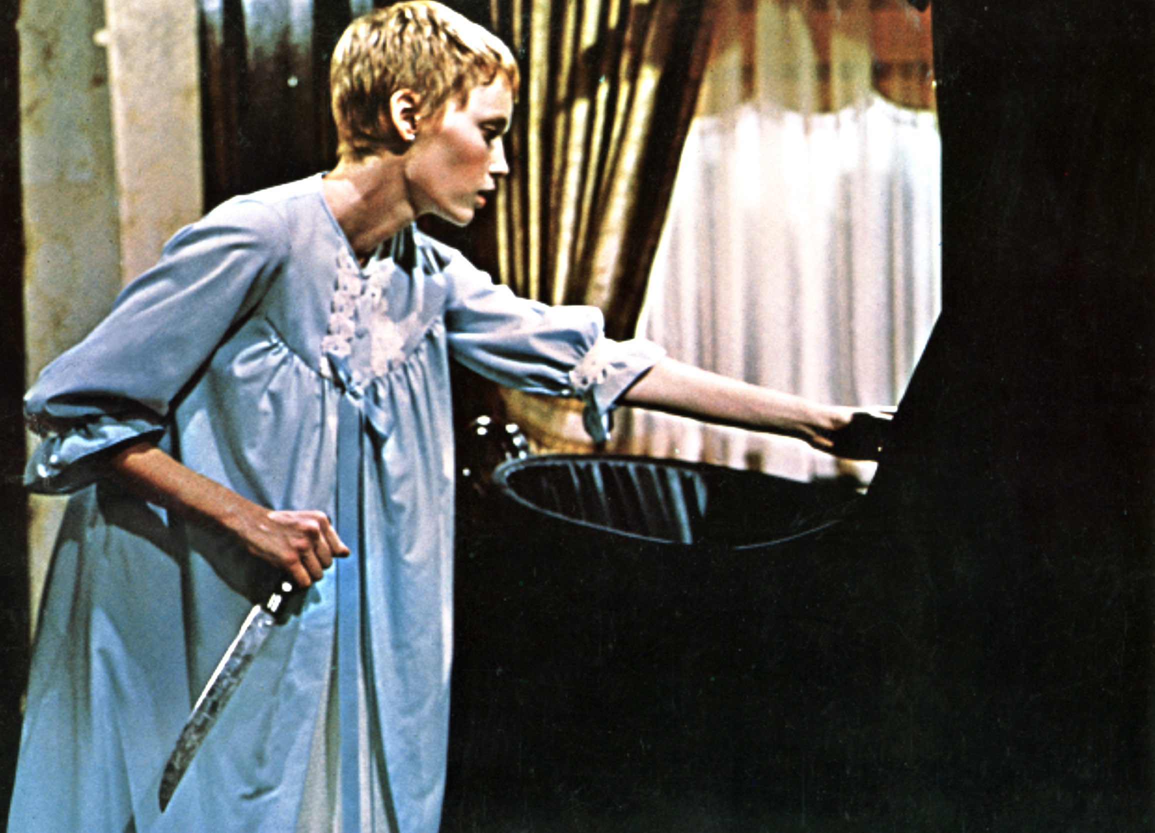 Mia Farrow holds a knife and approaches a crib