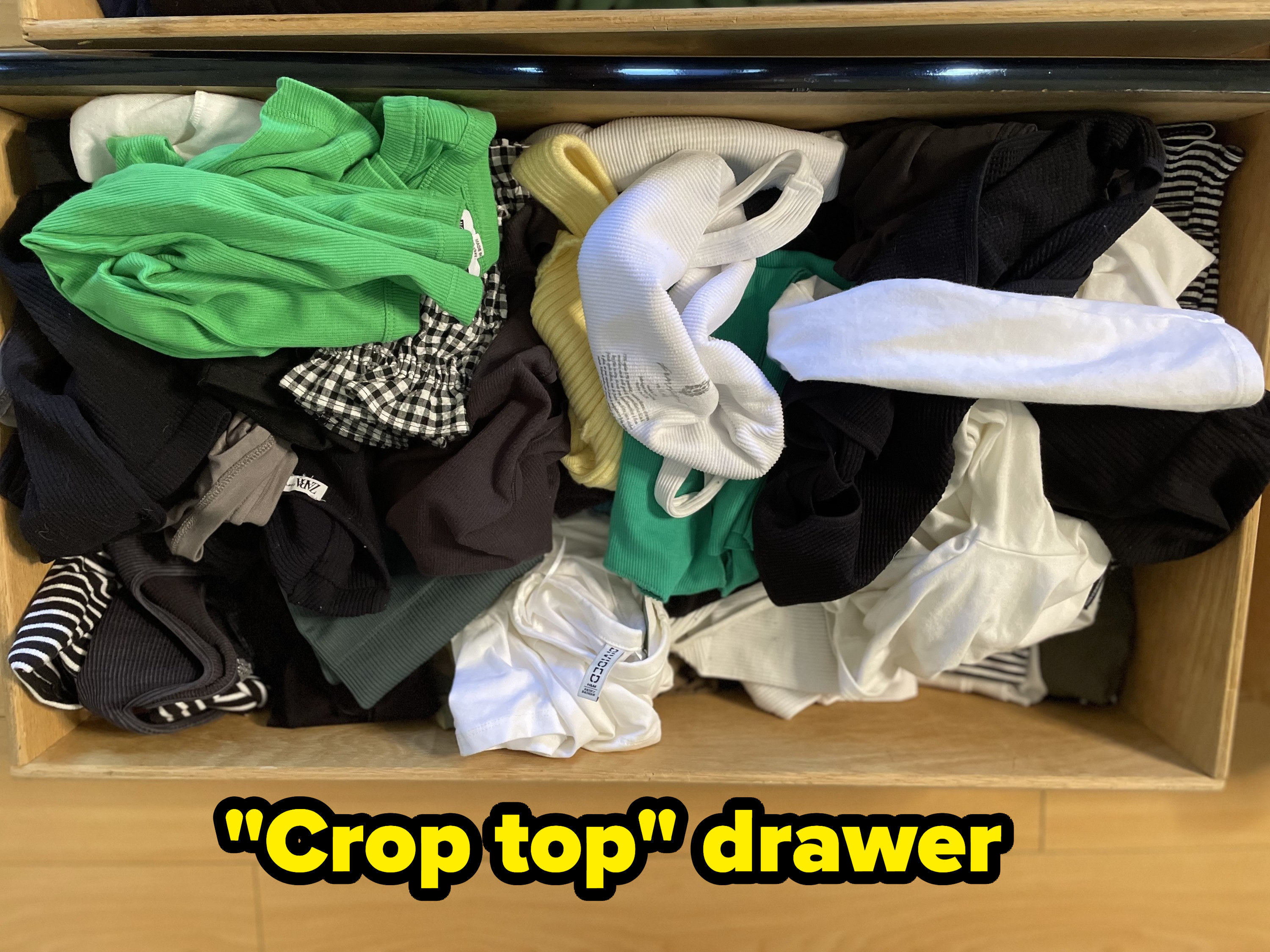 A top-down look of the writer&#x27;s crop top drawer before organizing