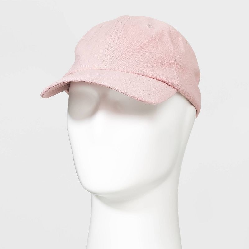 The pink cap on a white mannequin head