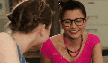 GIF two women laughing together in a classroom