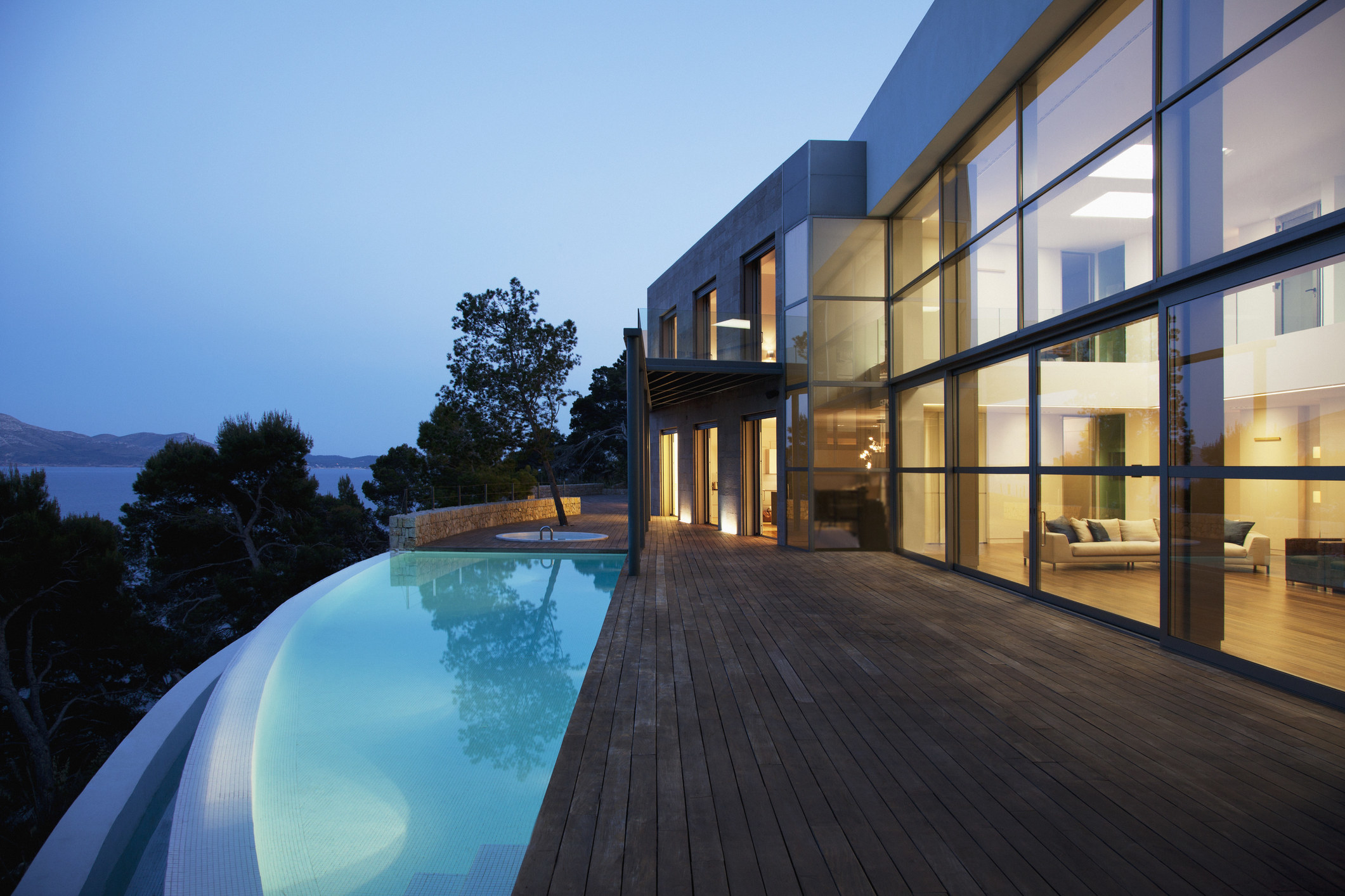 The exterior of a large house with an infinity pool