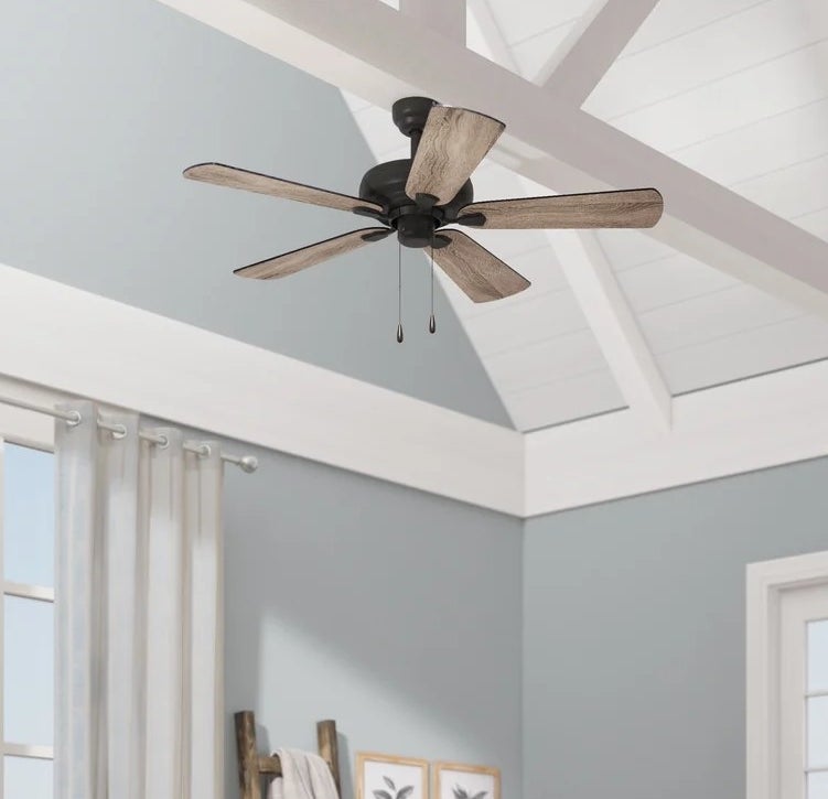 An image of a ceiling fan with blades, down rod, and light kit included