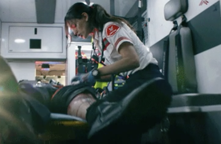 an EMT helping someone in an ambulance