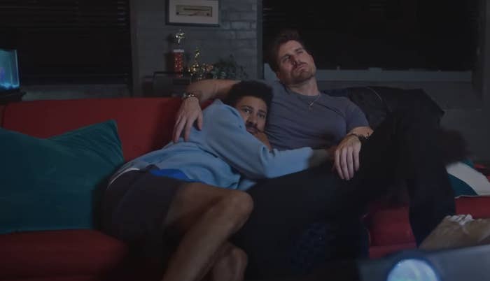 Keiynan Lonsdale and Marcus Rosner cuddle on the couch