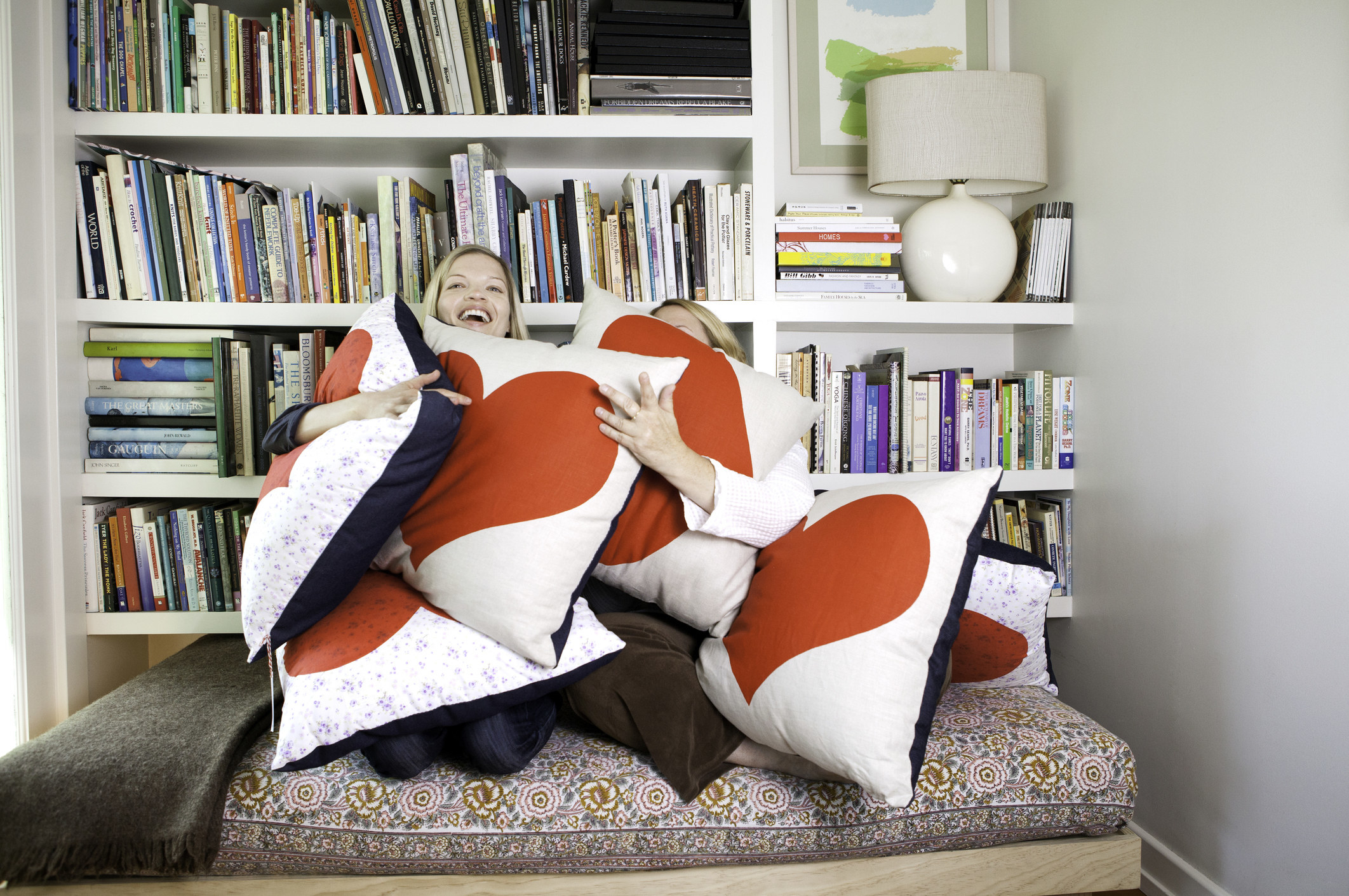 women on couch with many pillows