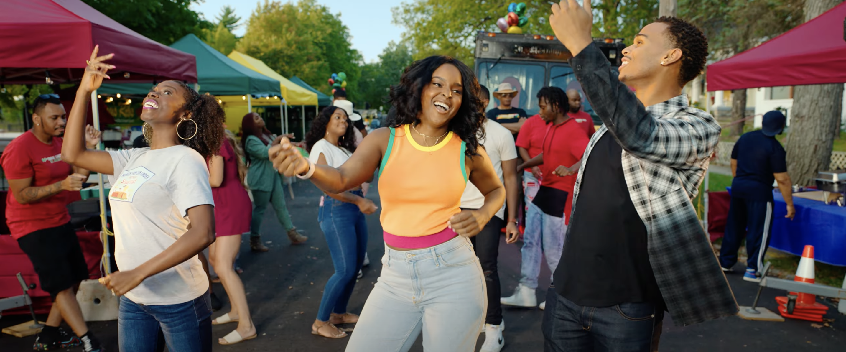 three friends dancing at a block party