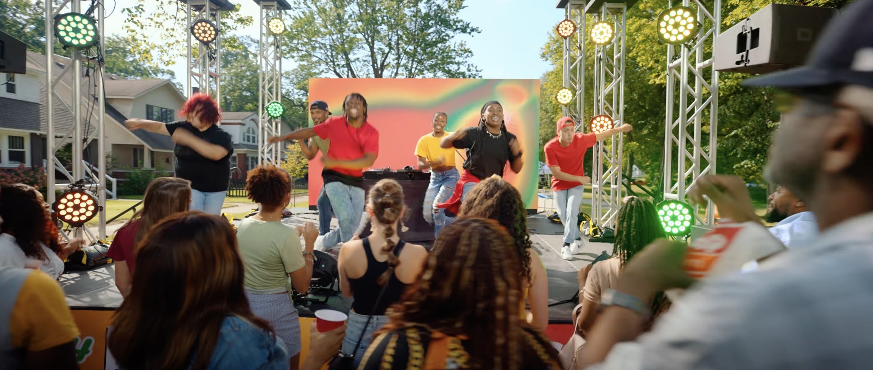 People dancing onstage at a block party