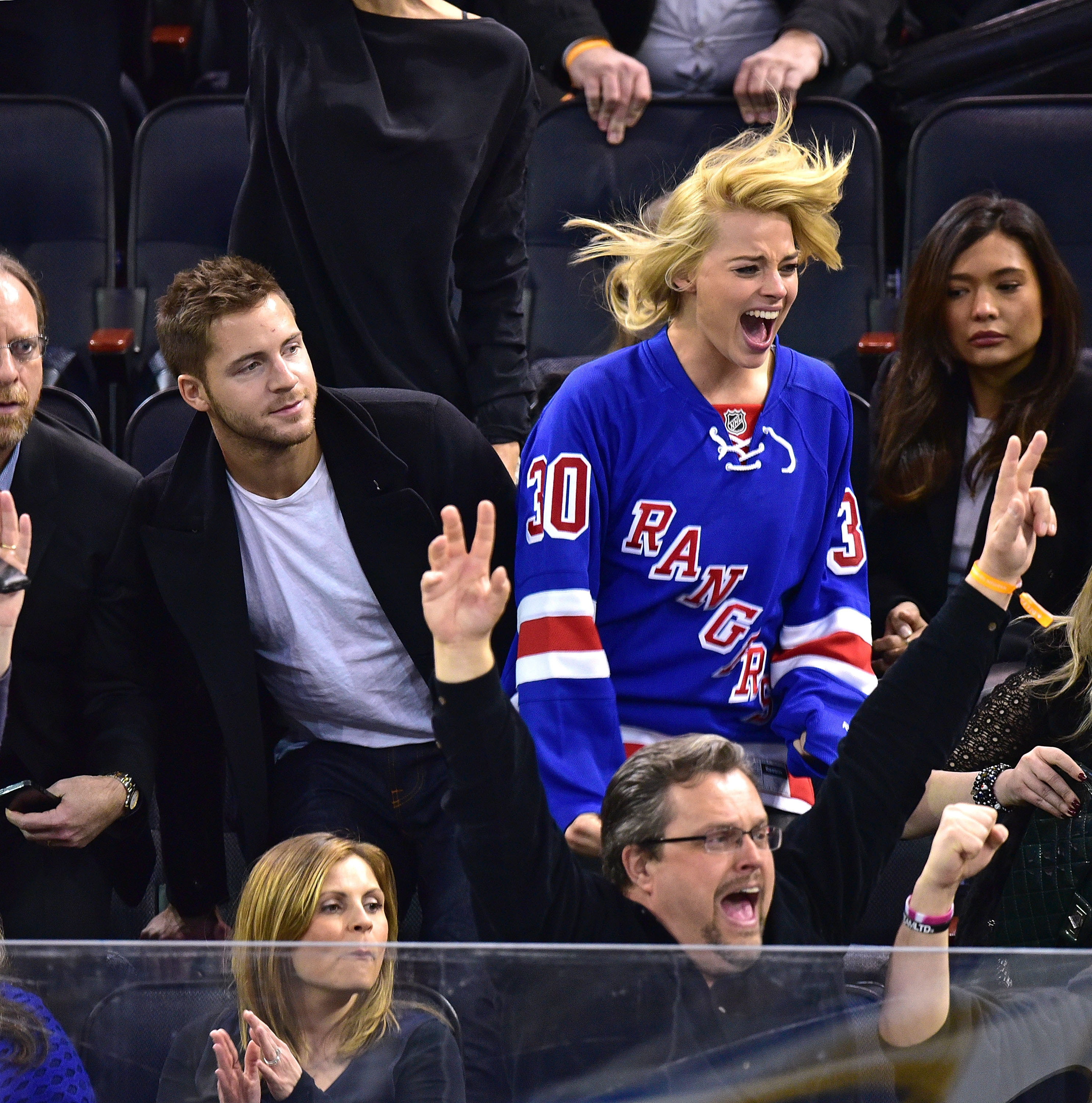 the two at a hockey game cheering