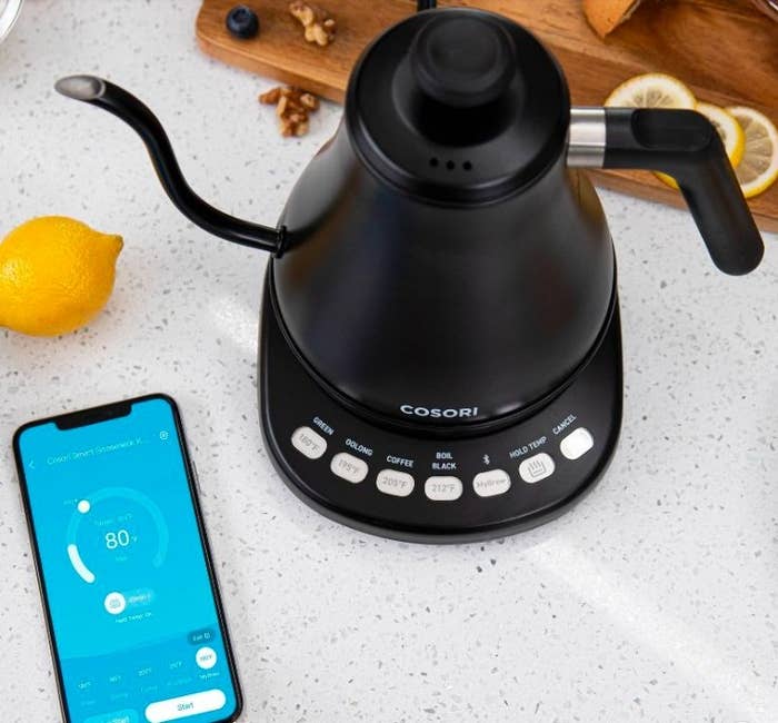 Gooseneck kettle next to phone with kettle app open