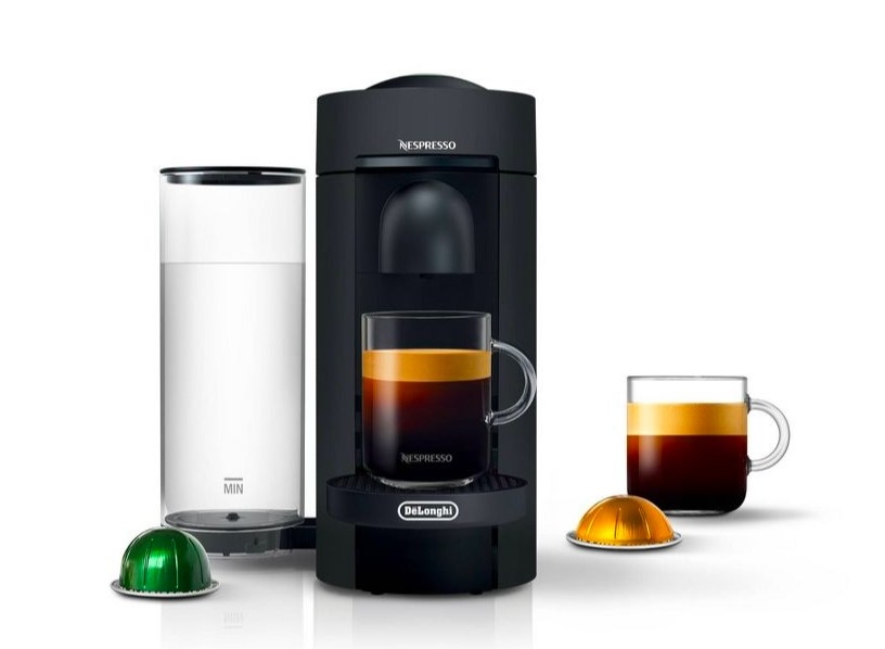 Coffee maker with coffee pods and glass mugs with coffee in them