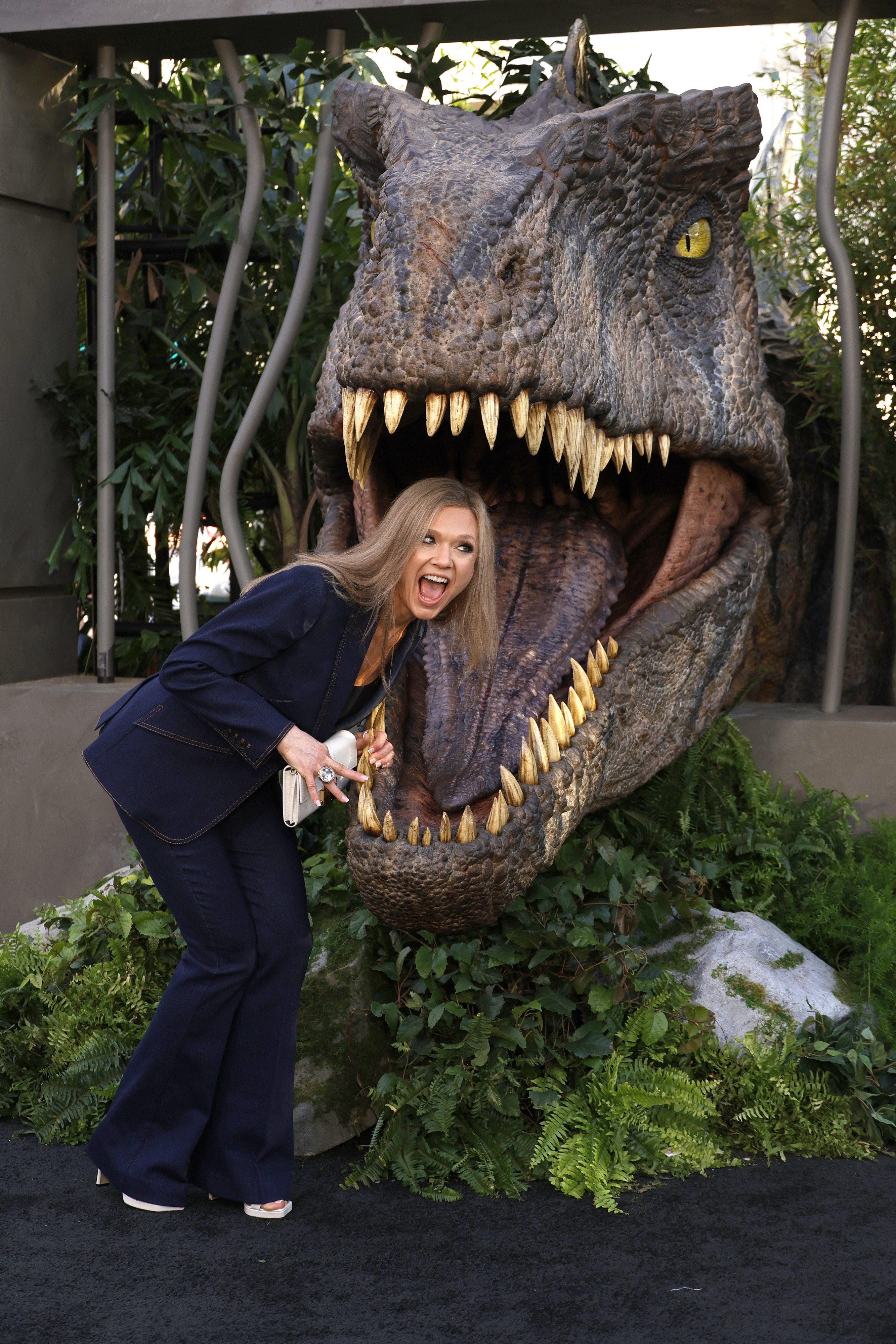 her posing with her head inside t-rex&#x27;s mouth
