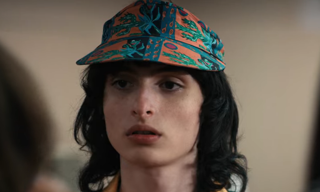 Finn as Mike wearing a cap