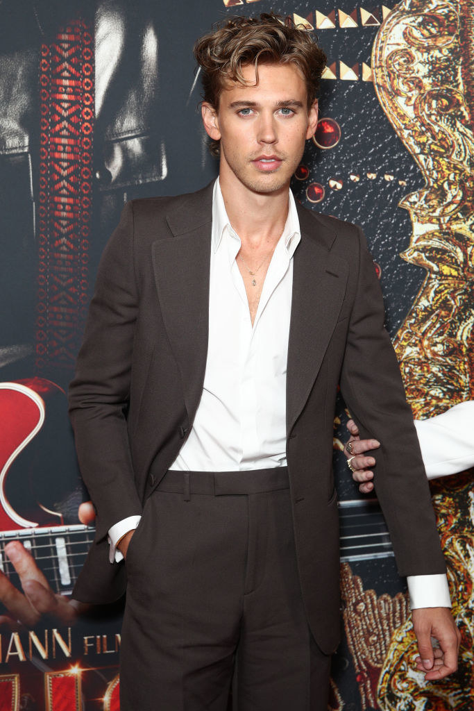 Austin Butler stands with his hand in his pocket