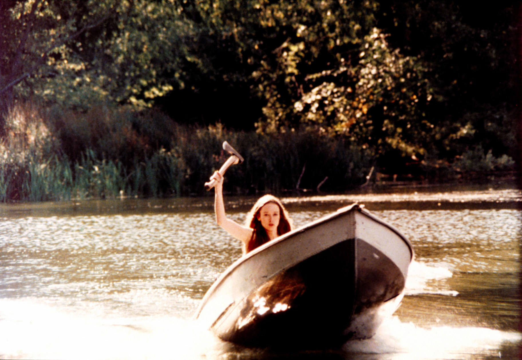 A woman holding an axe on a boat