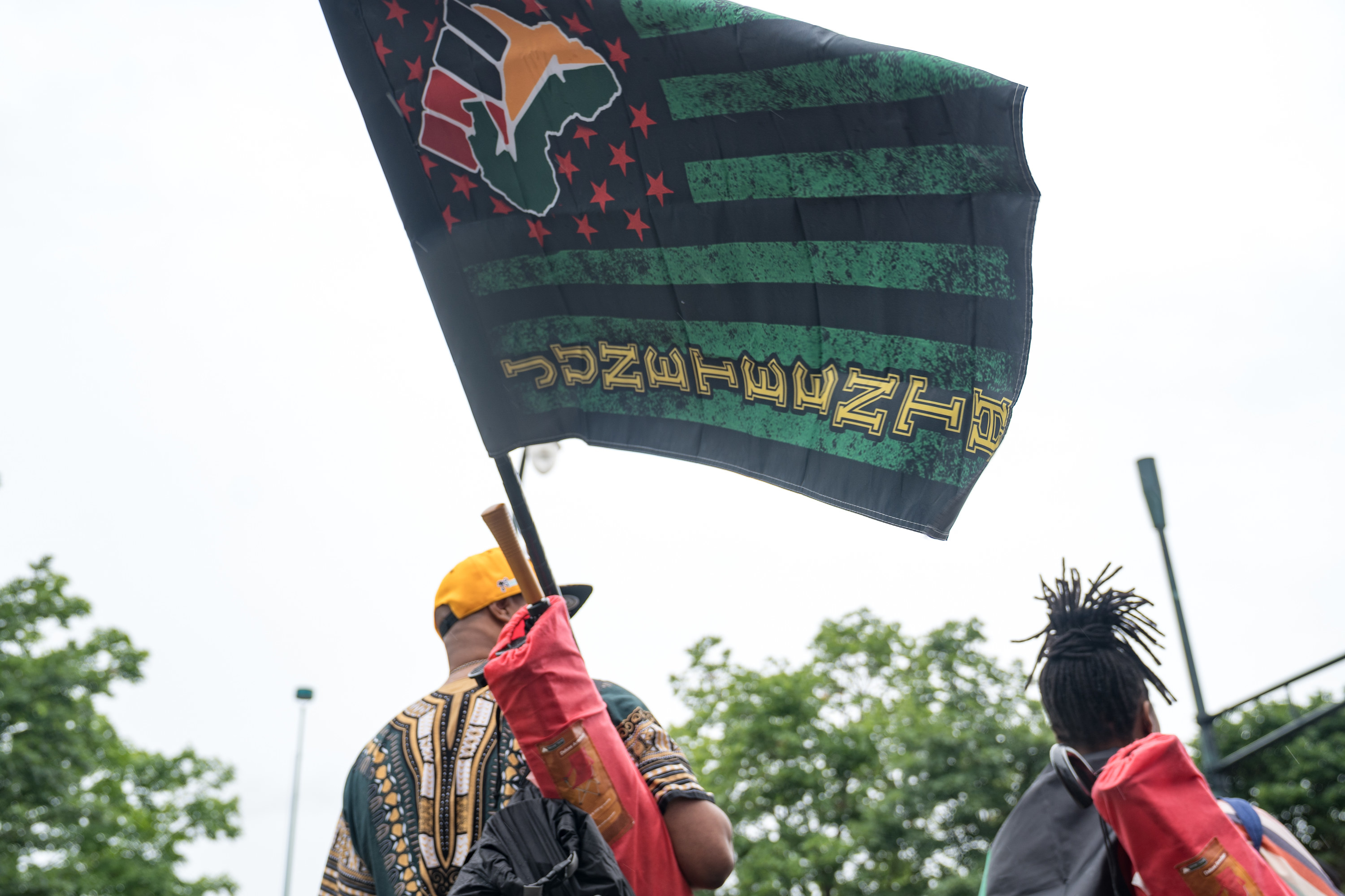 people holding up juneteenth flags