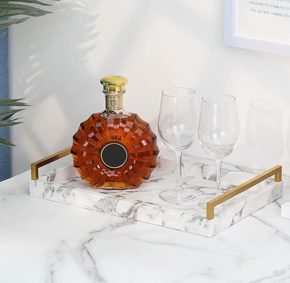 The tray with a bottle and two glasses on it