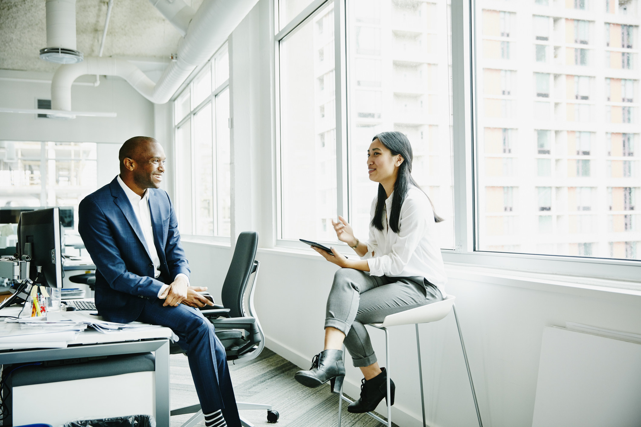 coworkers talking in office