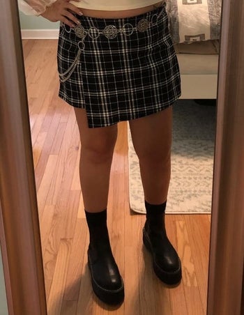 reviewer wearing the black and white plaid skort