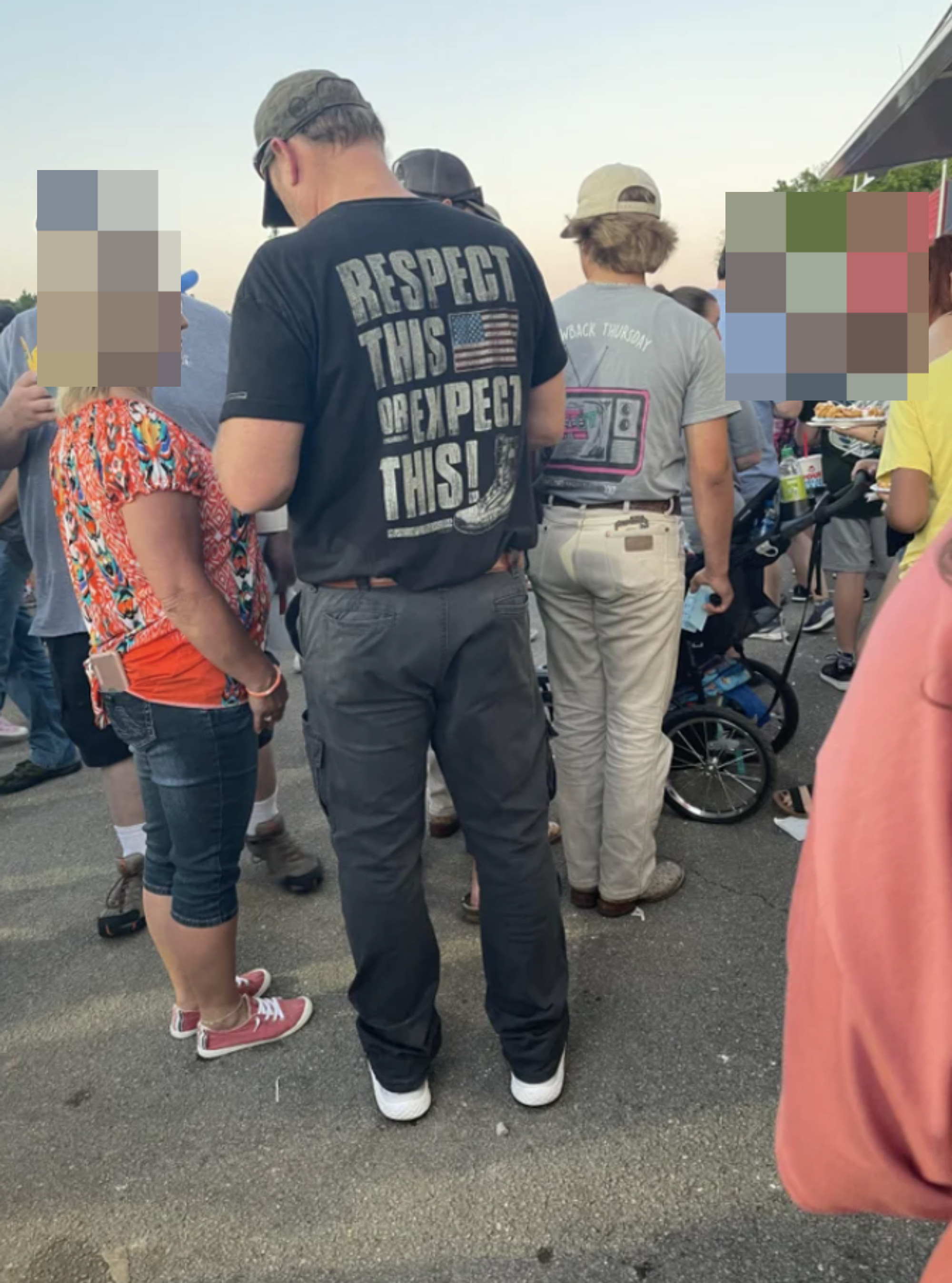 A man wearing a T-shirt that threatens to kick someone if they don&#x27;t respect his country