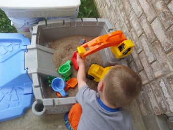 reviewer's child playing with the crane in the sandbox