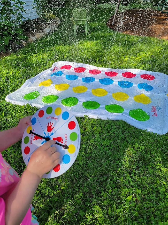 reviewer's photo with the spinner and the sprinkler mat