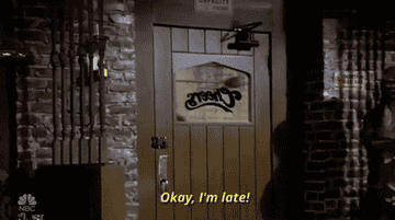 A gif of a person walking into a bar and saying &quot;okay, I&#x27;m late&quot;