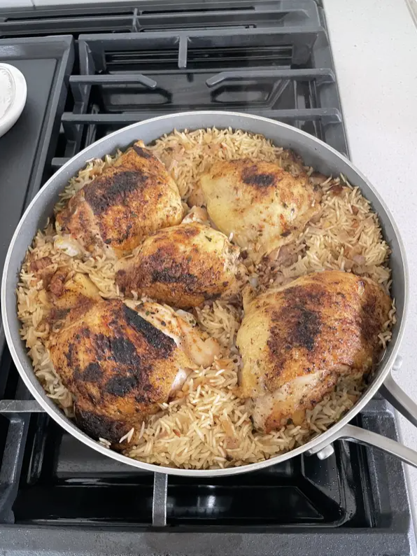 Chicken thighs and rice in a skillet