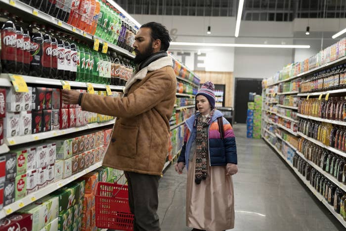 A man and a little girl at a grocery store.