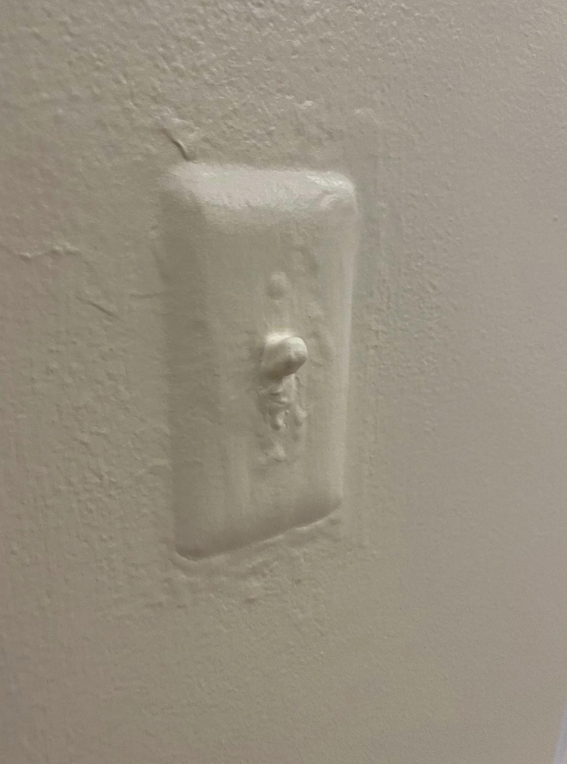 a light switch covered in paint