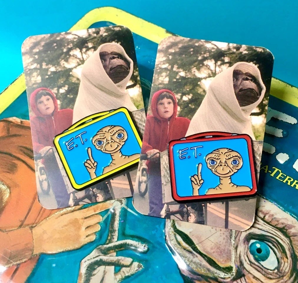 pin in the shape of a lunchbox with ET pointing up