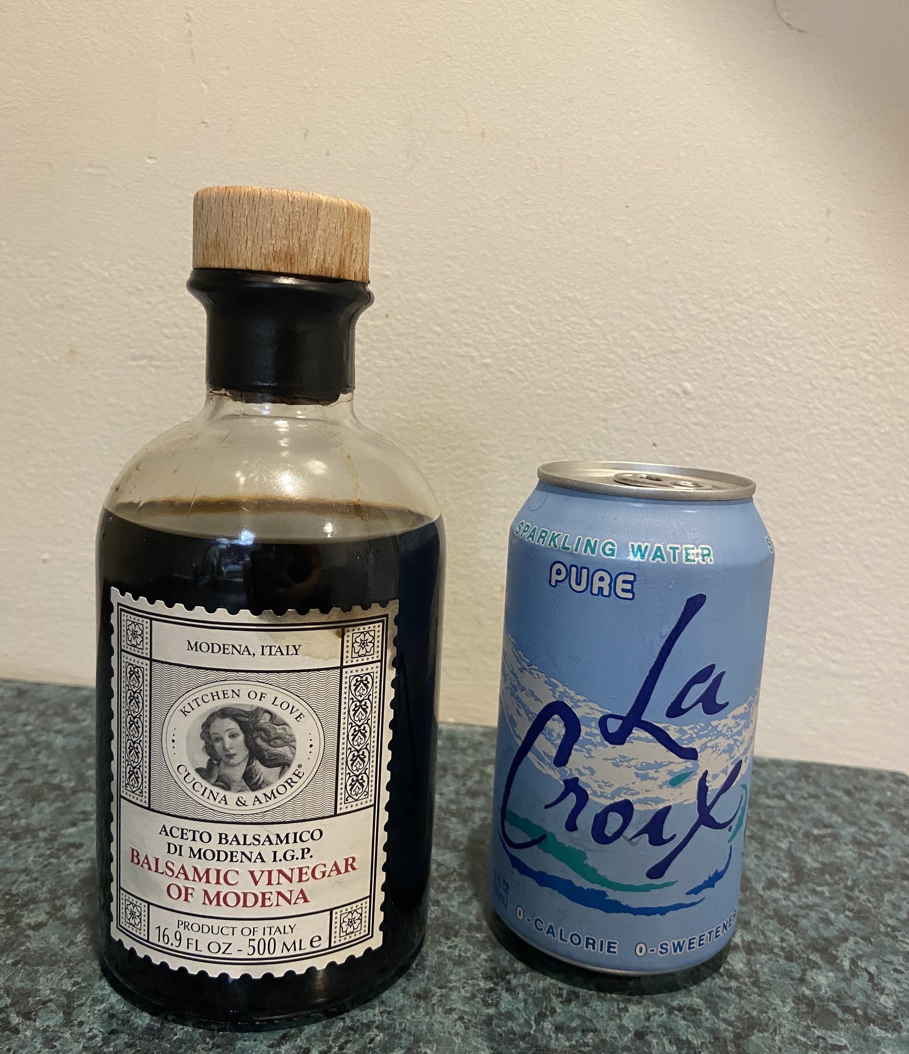A bottle of balsamic vinegar and a can of La Croix