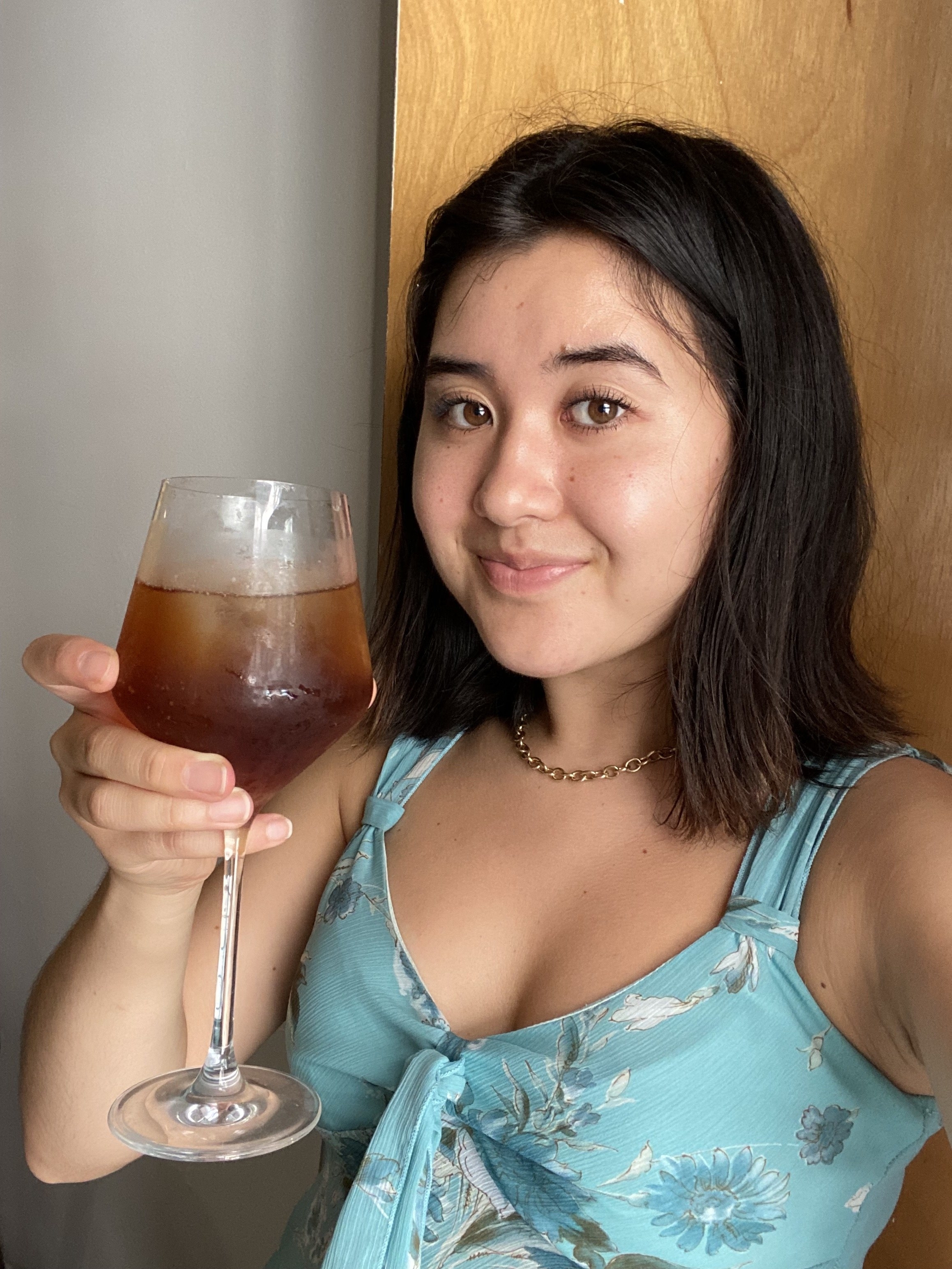 Woman holding a glass of the balsamic vinegar–La Croix mixture
