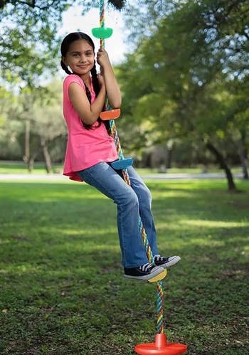 A child model hanging on the rope swing
