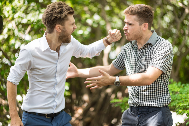 two people fighting outside