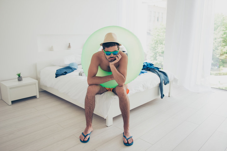 person sitting on the bed with a pool floaty around them